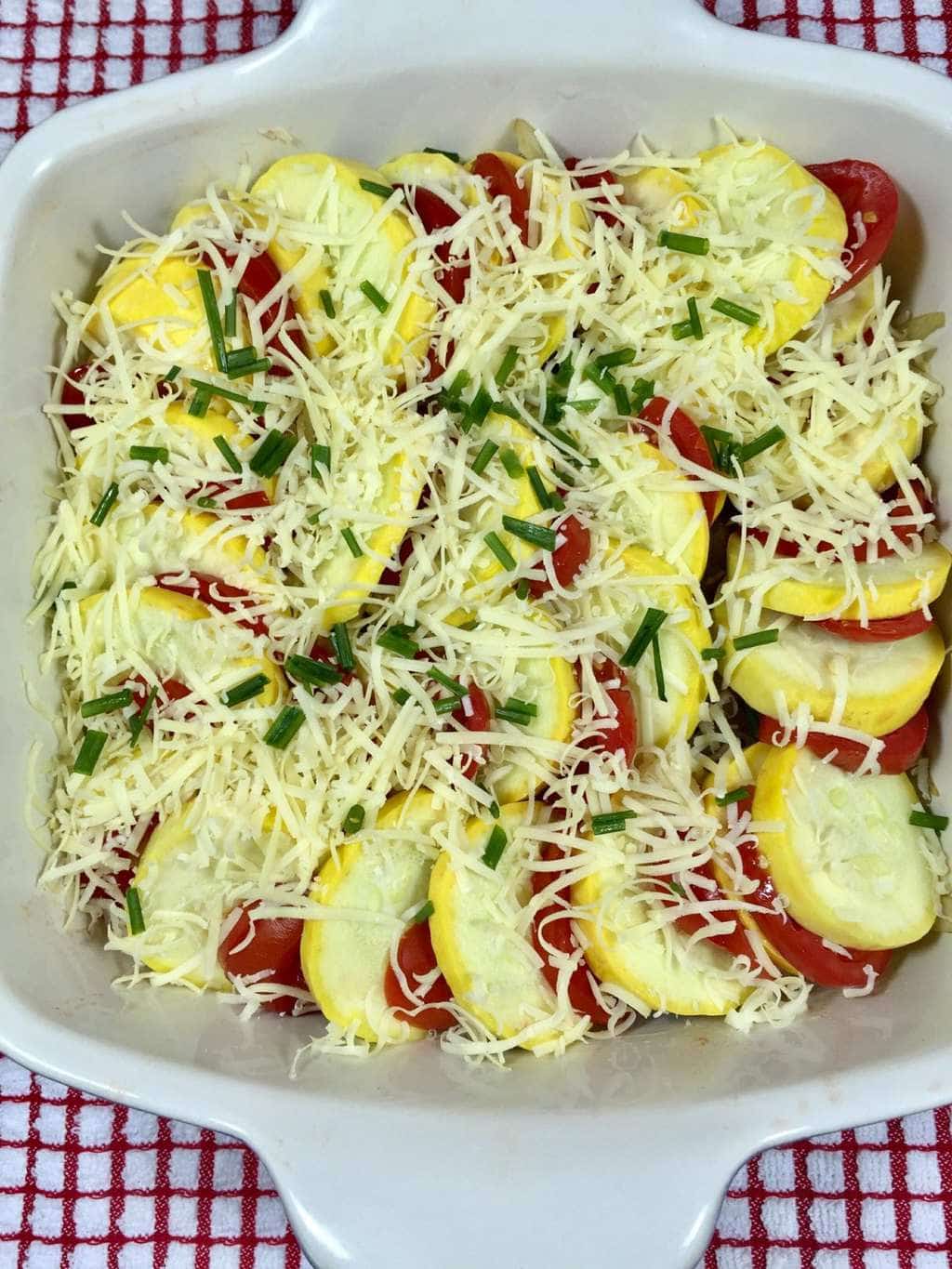Healthy squash, onions and tomatoes in a baking dish