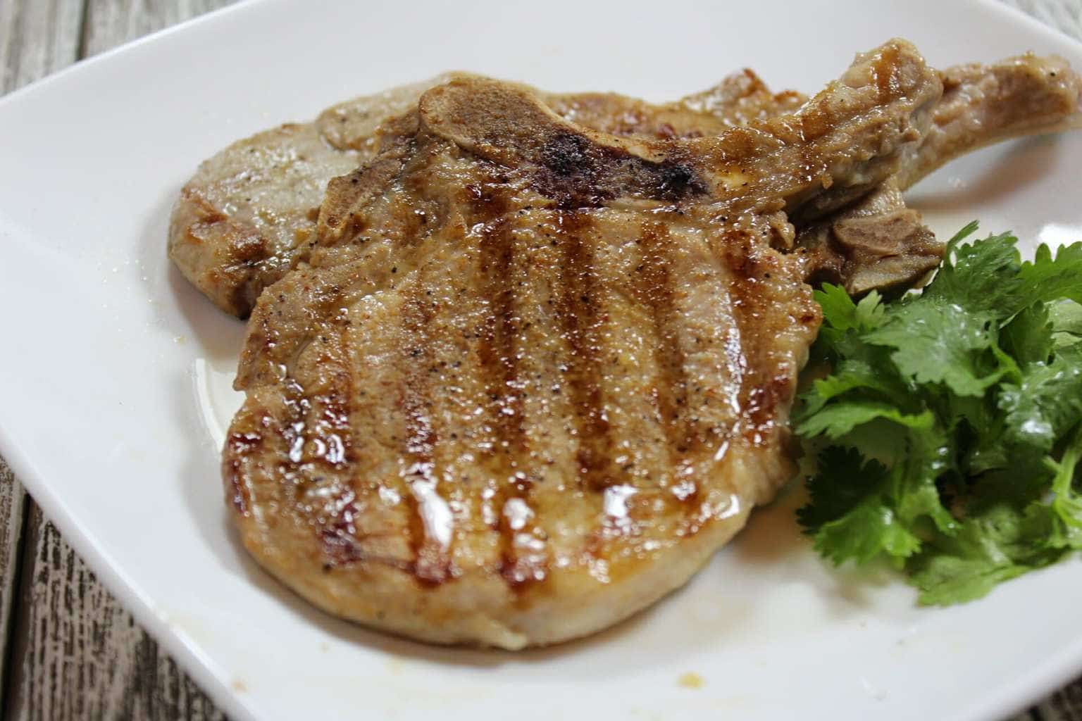 Grilled Pork Chops on a white plate.