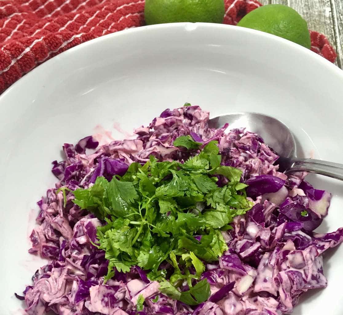Coleslaw with sriracha sauce in a bowl
