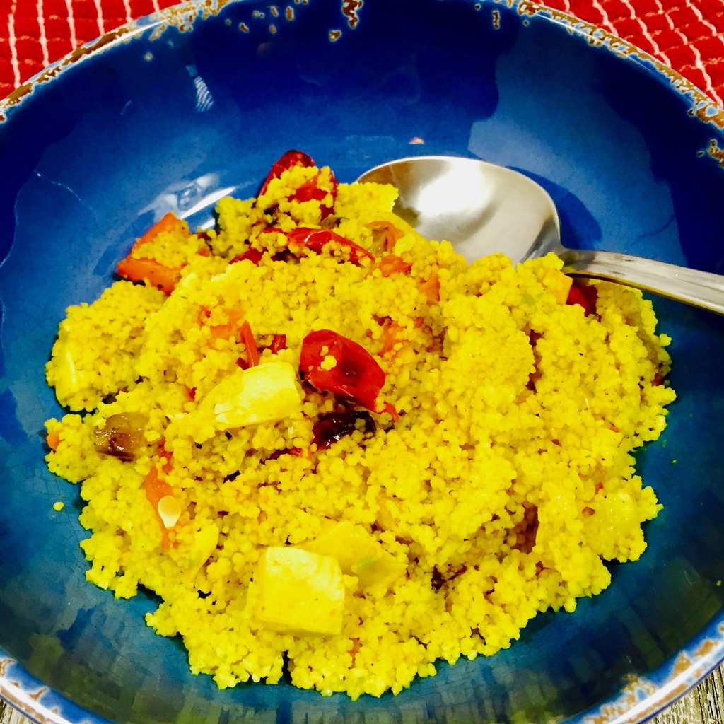 Curry Couscous and vegetables ina blue bowl