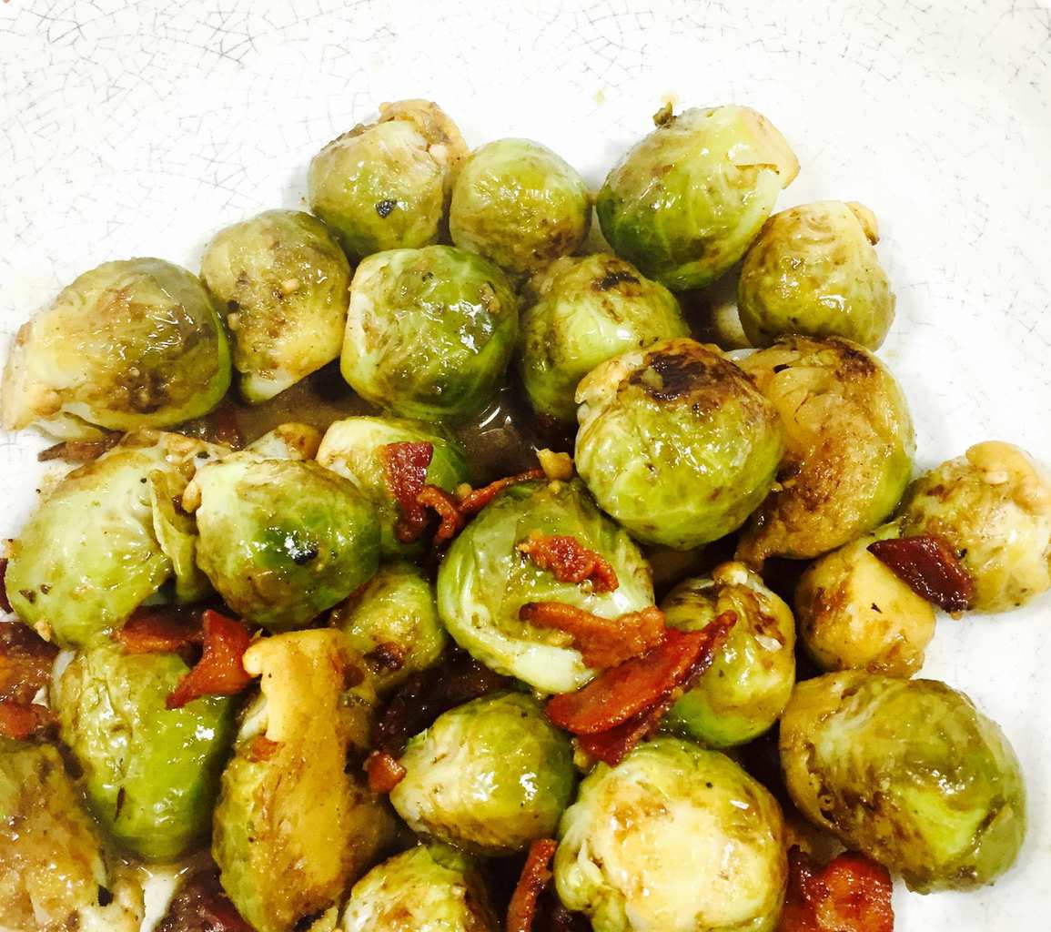 Cooked Brussels Sprouts with Bacon in a white bowl