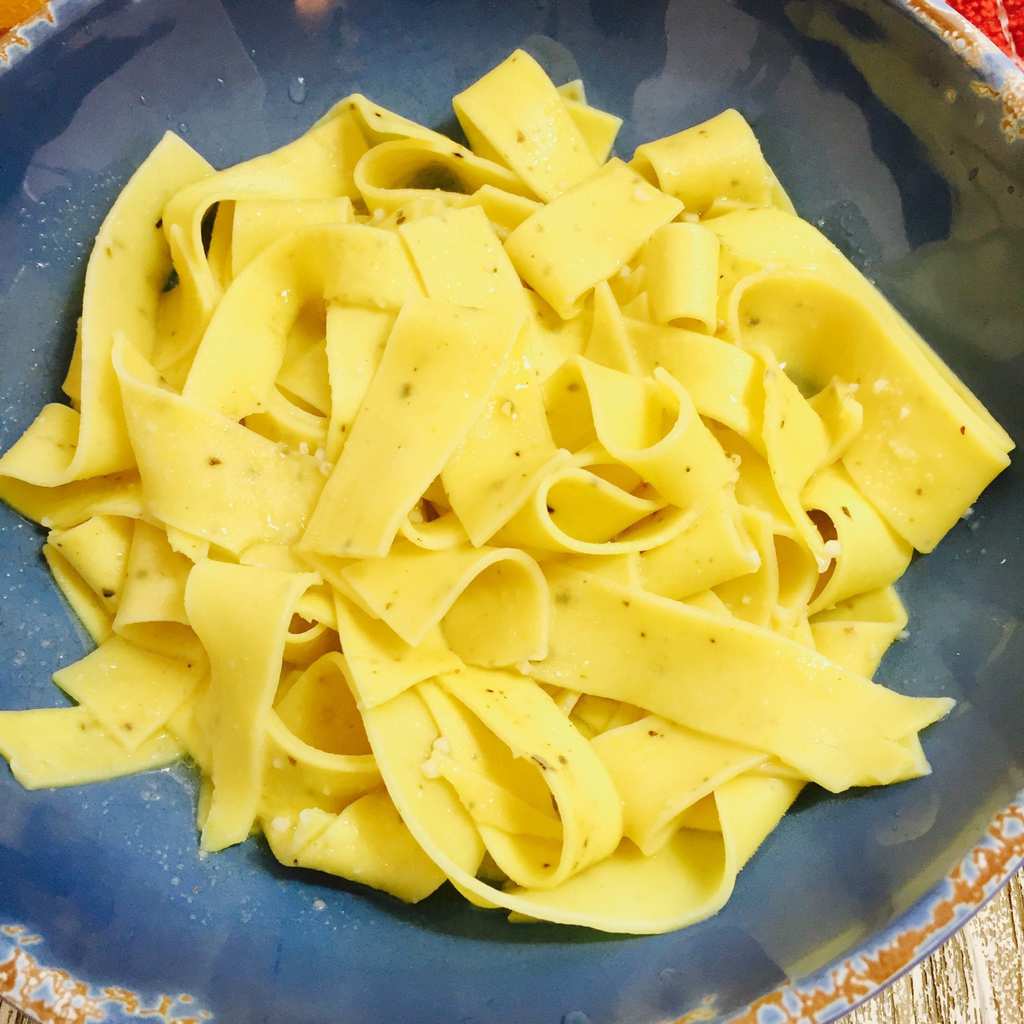 cooked Pappardelle on a blue plate