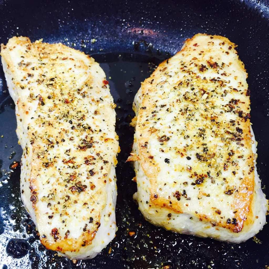 Seared pork chops in pan