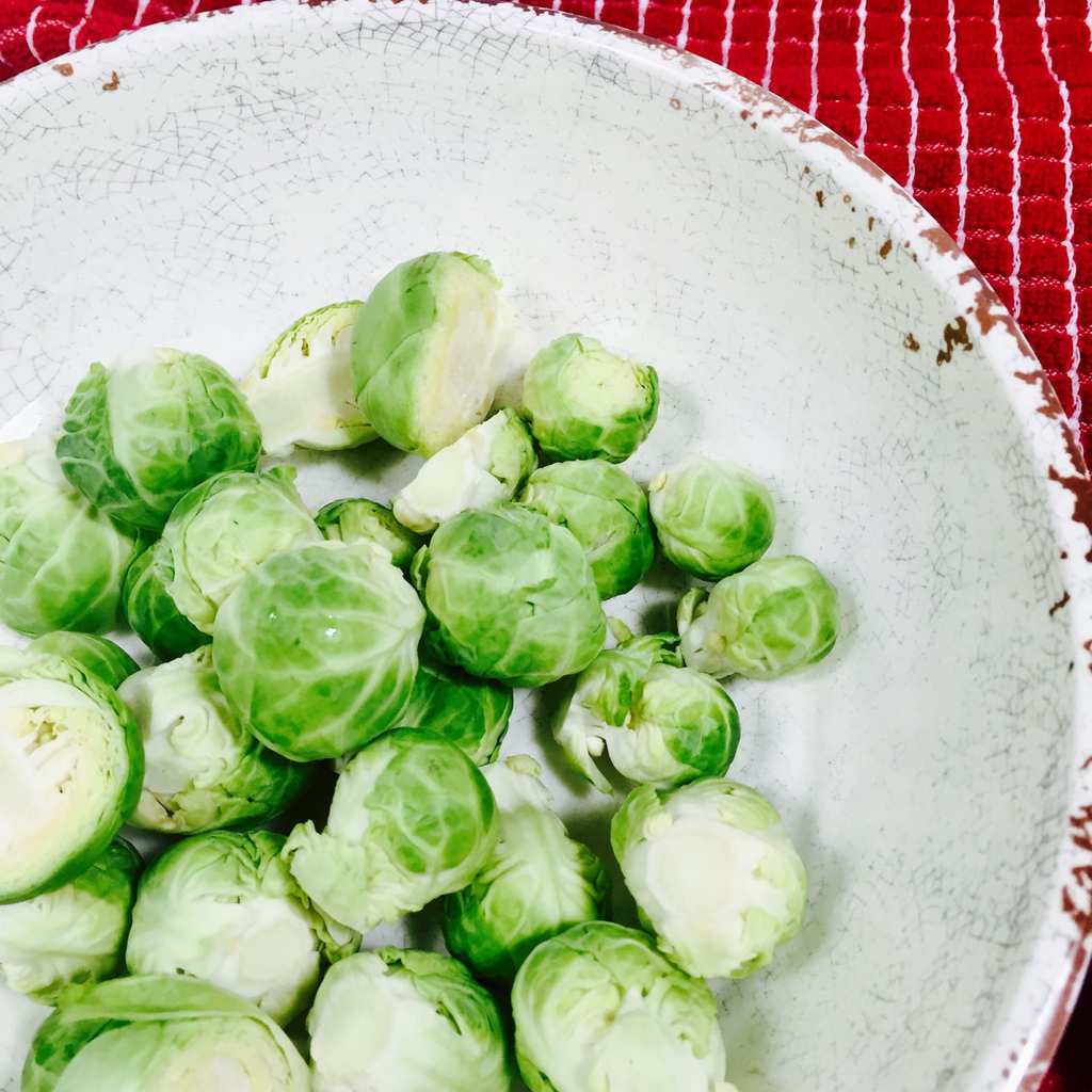 Raw Brussels Sprouts in a white bowl