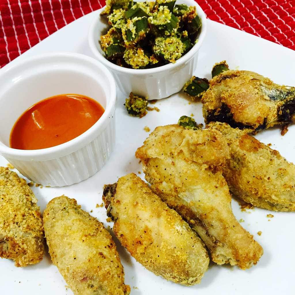 Crispy chicken wings with sauce and okra