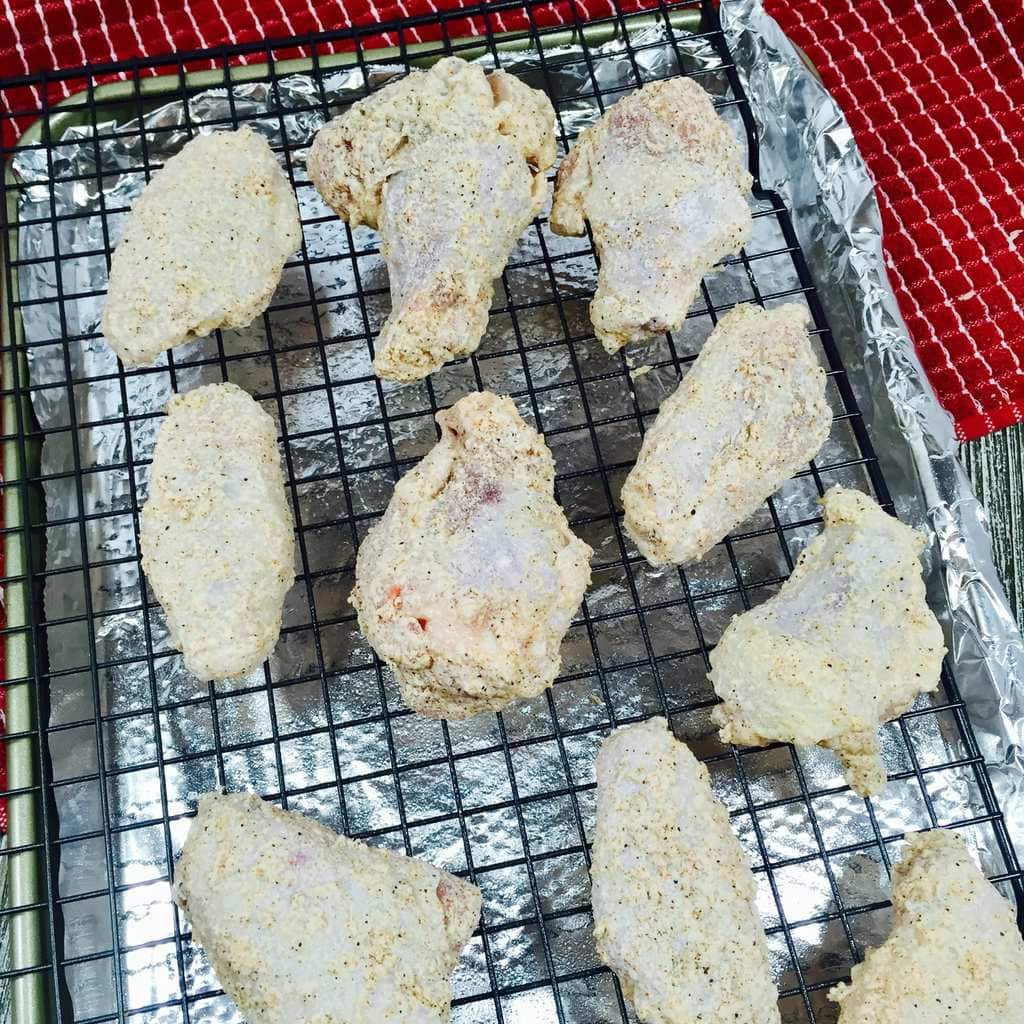Crispy Cajun Wings Spiced Chicken Wings on a wire rack for baking