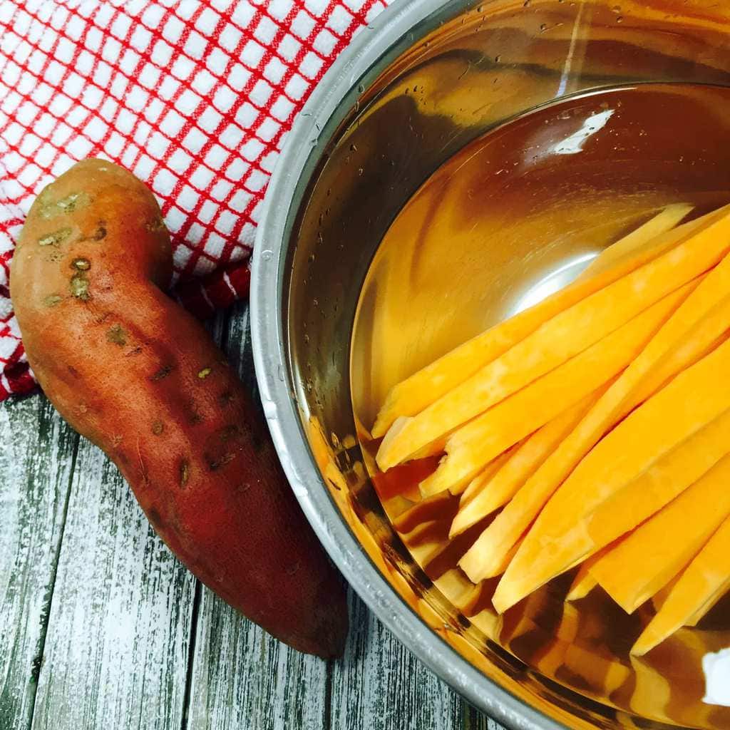 a whole sweet potato and another sweet potato cut into fries