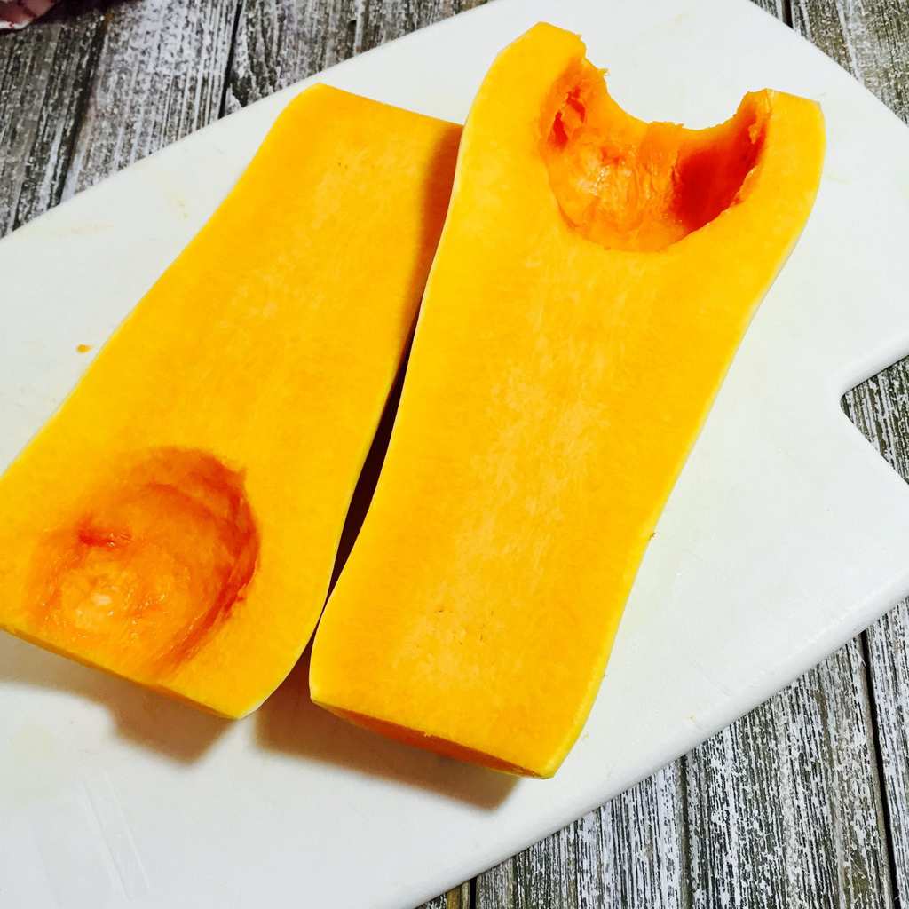 Cut butternut squash on a white cutting board