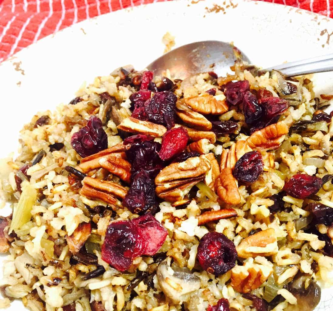 Wild rice with cranberries and pecans on a white plate