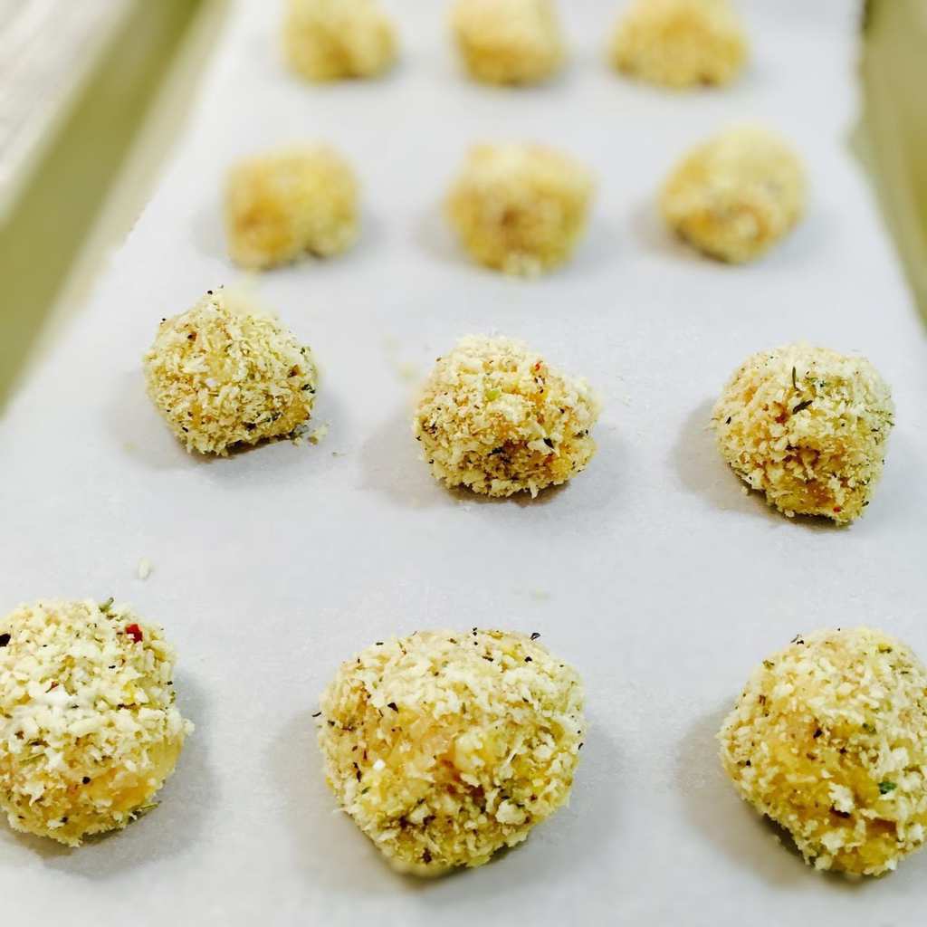 Cooked chicken meatballs on a sheet pan