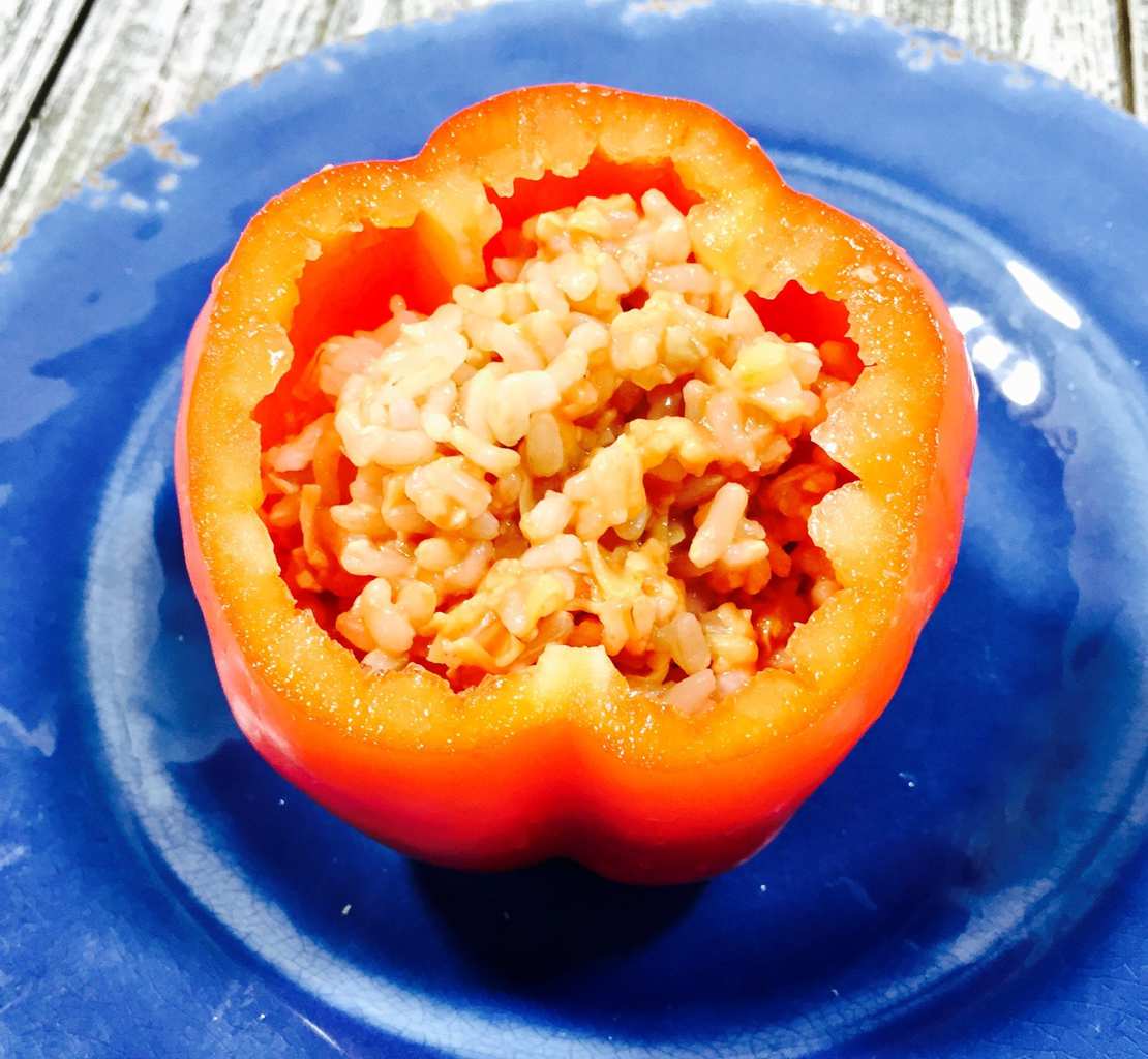 Stuffed pepper with rice on a blue plate