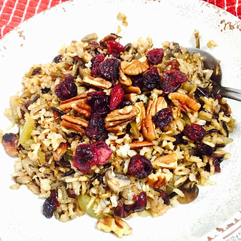 Wild rice with cranberries and pecans on a white plate