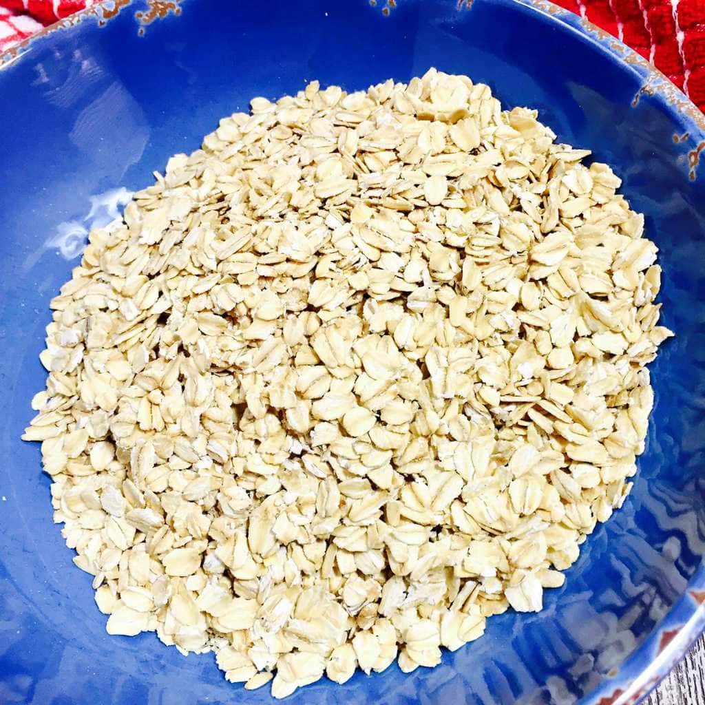 dry rolled oats in a blue bowl