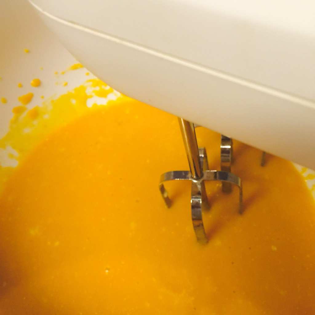 mixing pumpkin muffin batter with a beater