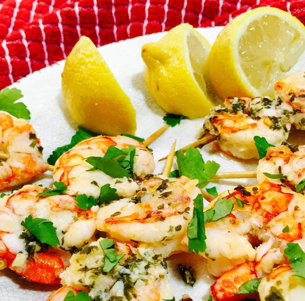 Shrimp Scampi and lemons on a white plate