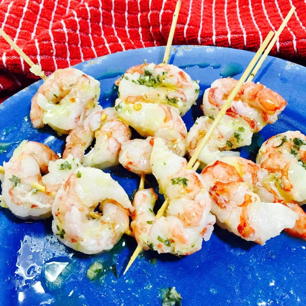 skewers shrimp on a blue plate