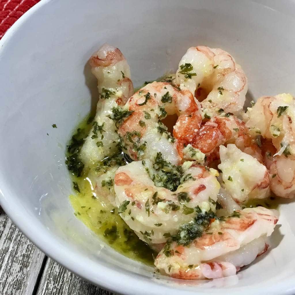 shrimp marinading in a white bowl