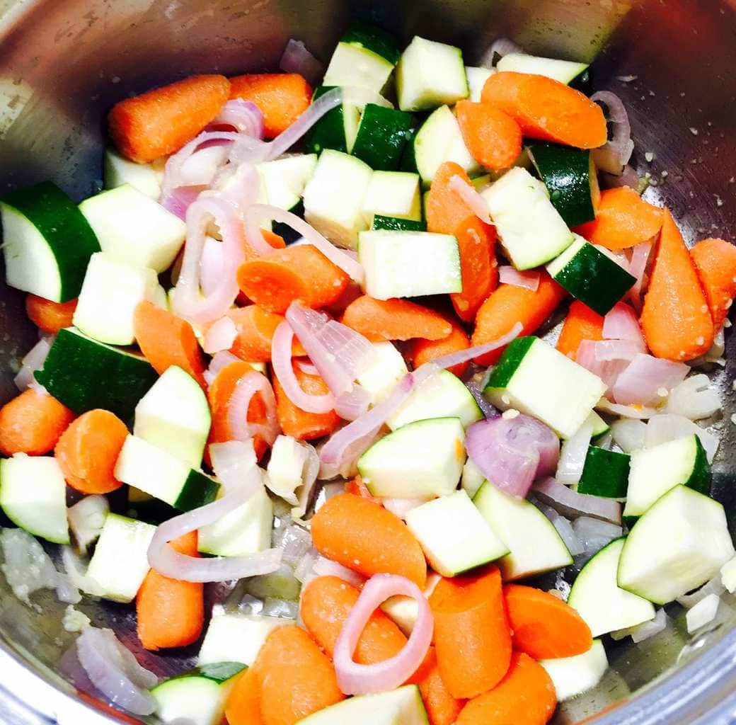 Carrots, onions and zucchini in a cooking pot