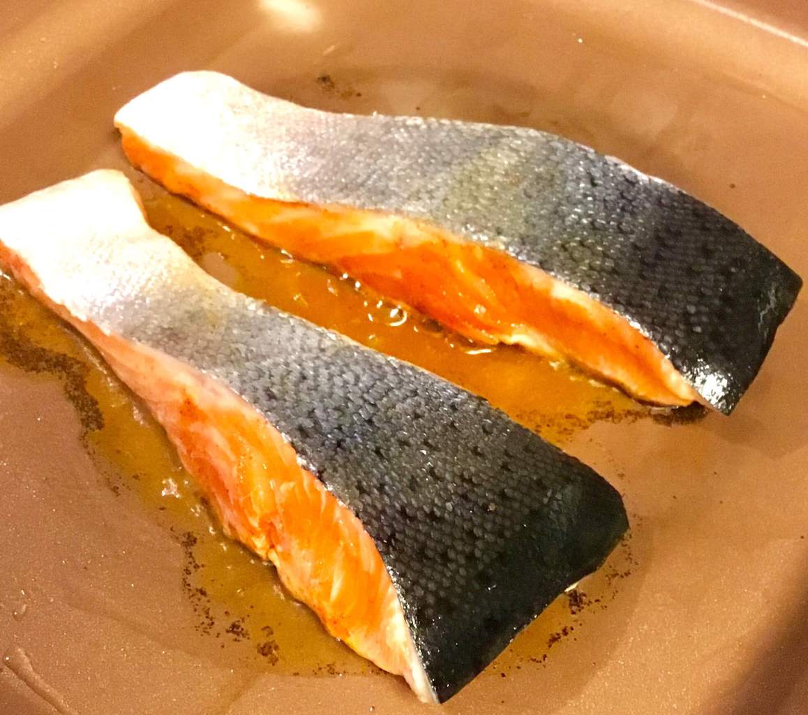 salmon searing in a copper pan