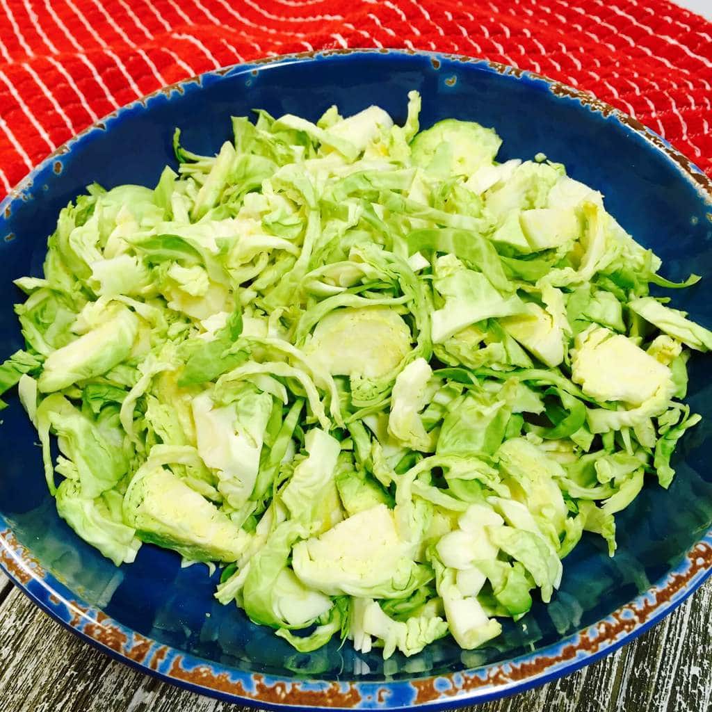 Shredded Brussels Sprouts in a blue bowl